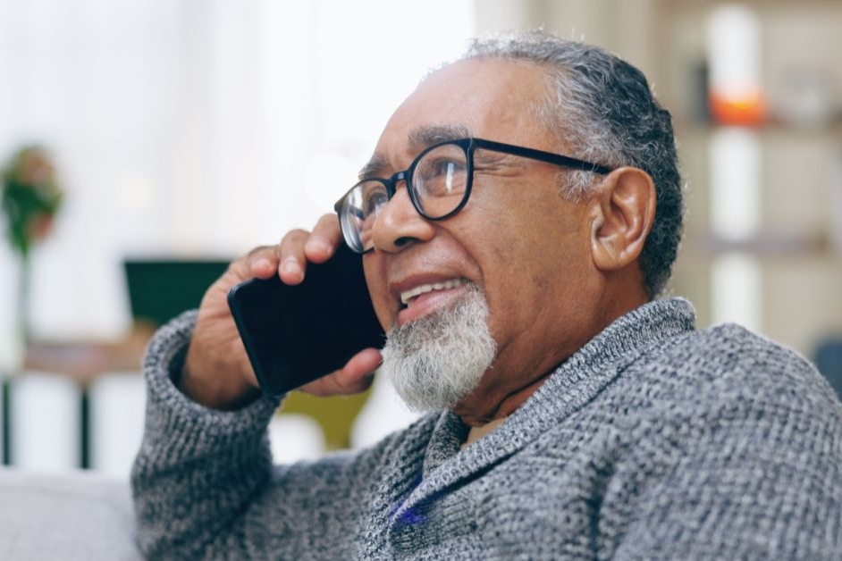 Elderly person using a smartphone for remote Liaison Care Section 117 review
