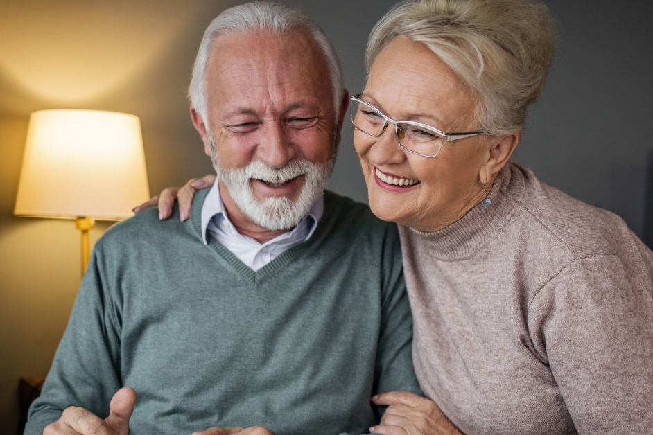 Elderly couple sitting together using a laptop during a continuing healthcare assessment with Liaison Care.