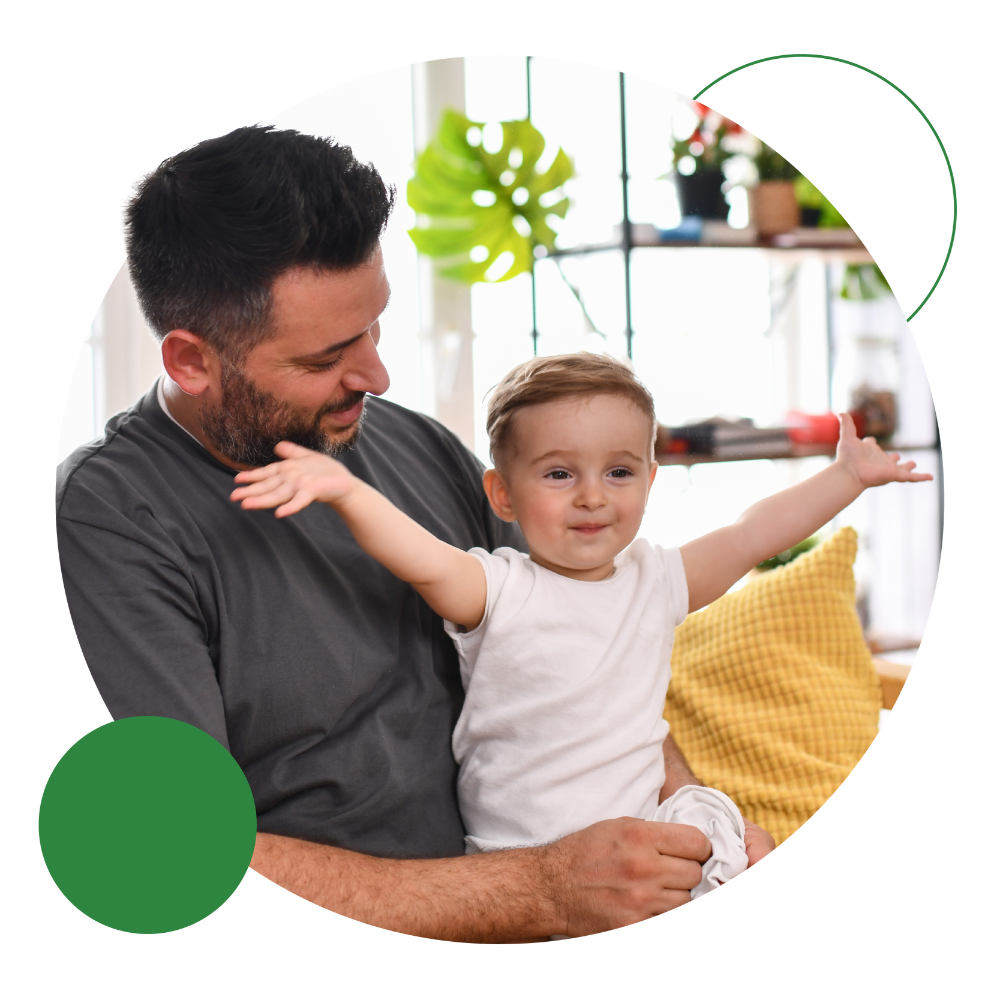 Adult Sat With Their Happy Young Child 1 adult sat with their happy young child