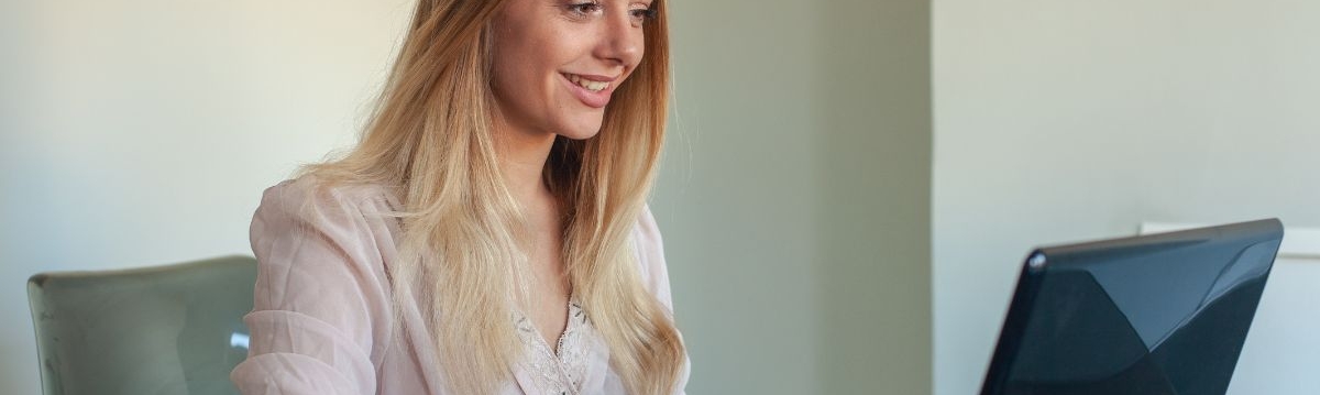 Liaison Care CHC nurse working at a desk on a laptop, collaborating on a project with an Integrated Care Board (ICB)